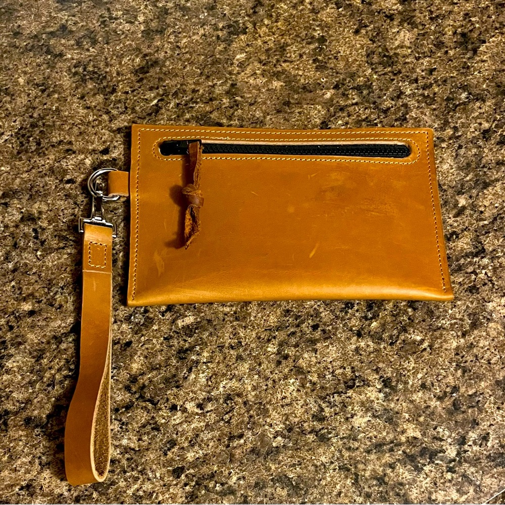Beautiful HANDMADE LEATHER wristlet. Never used. Inside pocket for 3 cards